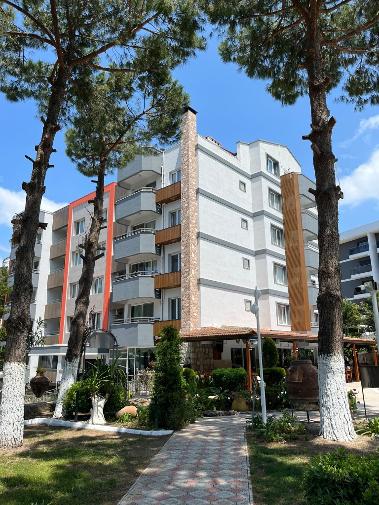Opus Apart Hotel Building and Palm Trees